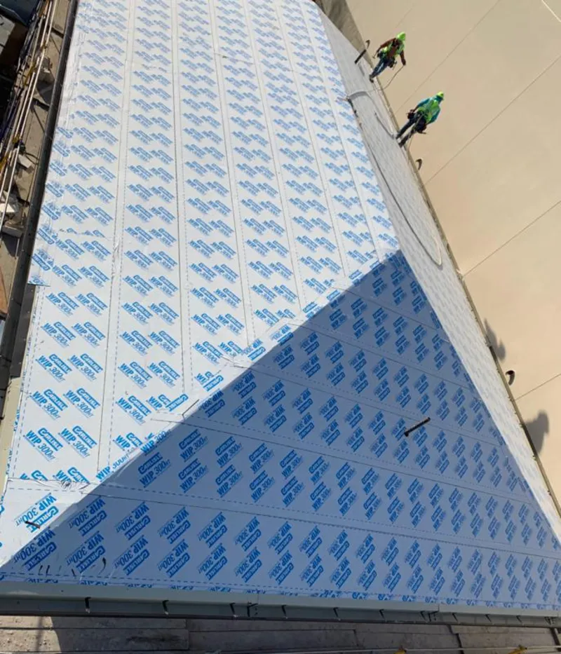 Professional roofers installing underlayment on a metal roof in Emporia